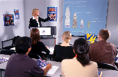 Men and women taking America's Boating Course in a classroom setting with a female instructor