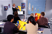 Men and women taking America's Boating Course in a classroom setting with a female instuctor